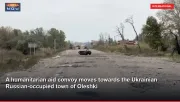 A humanitarian aid convoy moves towards the Ukrainian Russian-occupied town of Oleshki